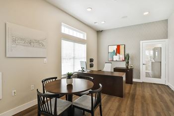 A conference room with a table and chairs and a window